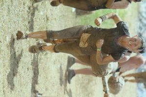 Roselee smiling muddy face at Spartan
