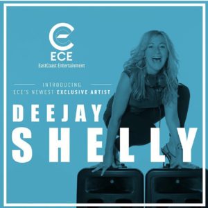 Female DJ standing on JBL speakers 