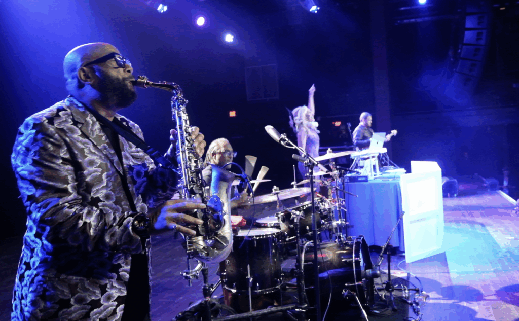 DeeJay Shelly performing with the ElectriX, a live DJ band with saxophone, drums, and guitar, at the Fillmore Philly