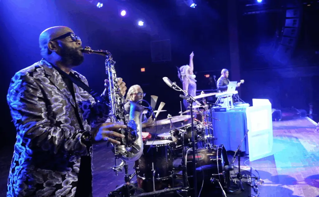 DeeJay Shelly performing with the ElectriX, a live DJ band with saxophone, drums, and guitar, at the Fillmore Philly