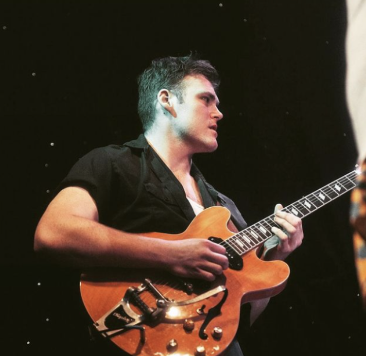 Raymond Paul on electric guitar