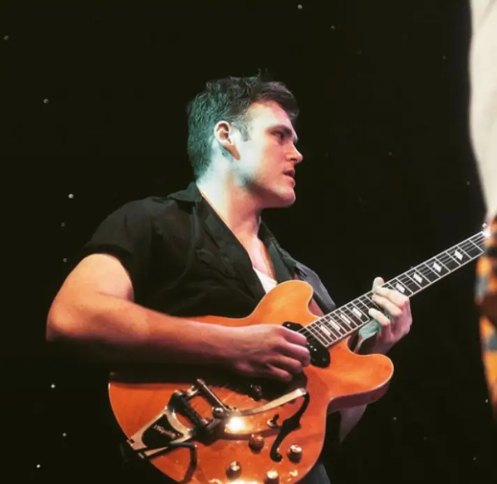 Raymond Paul on electric guitar