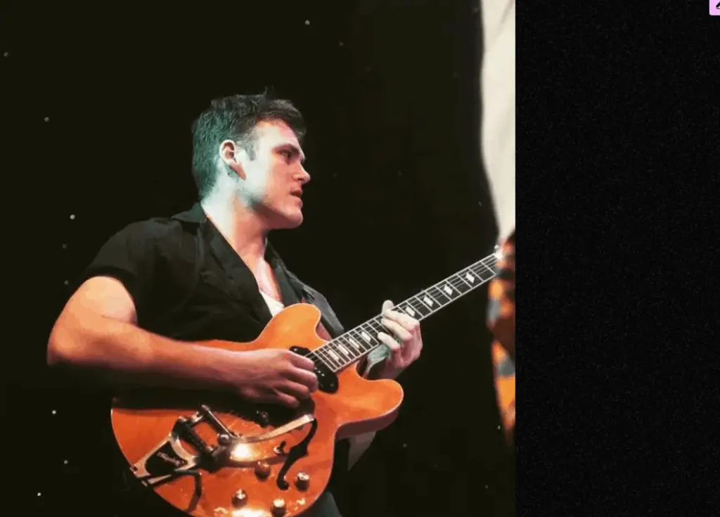 Raymond Paul playing guitar